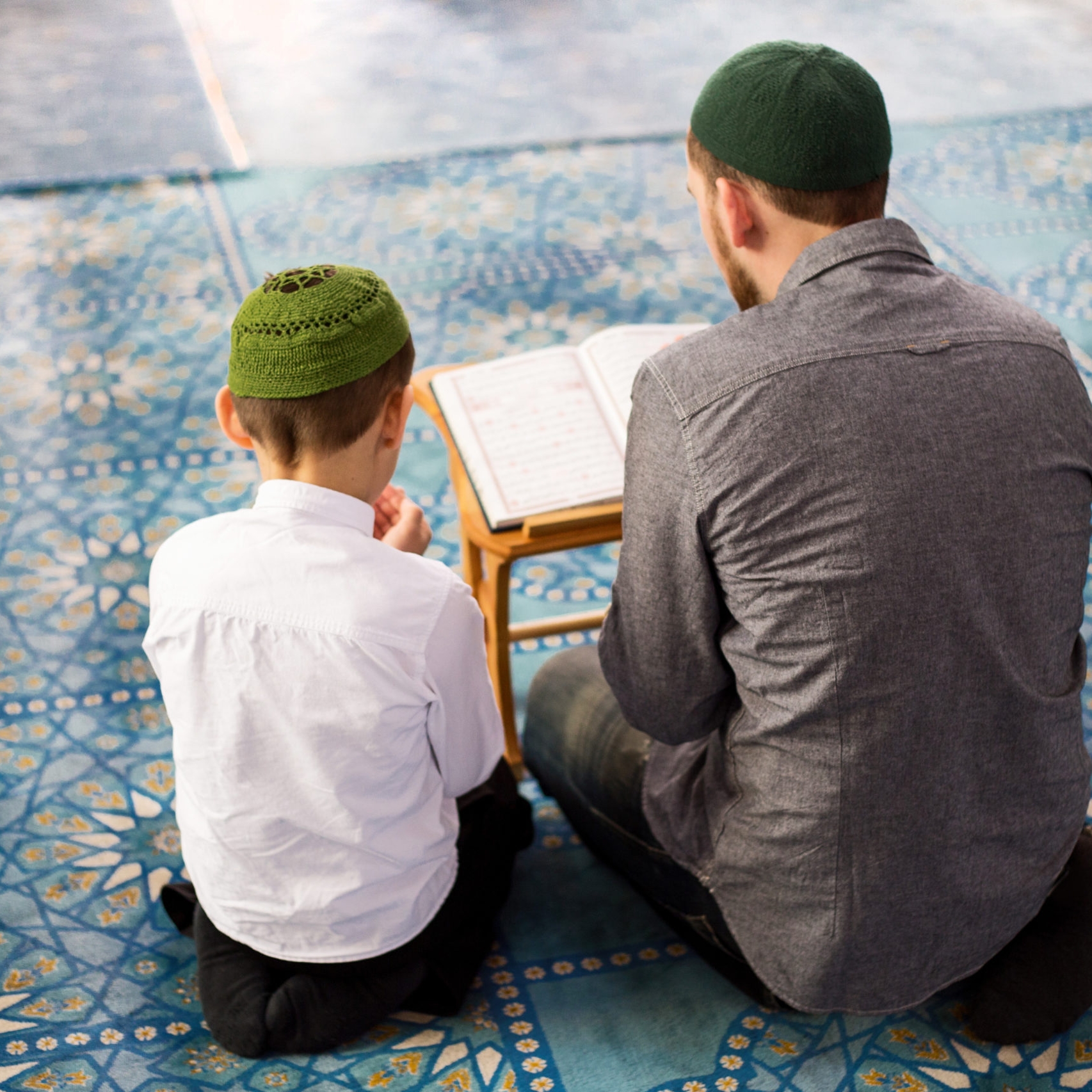 Father and sons pray in the mosque Father and sons pray in the mosque